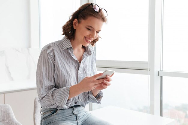 Woman looking at her phone, smiling